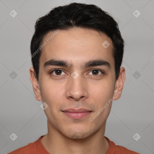 Joyful white young-adult male with short  black hair and brown eyes