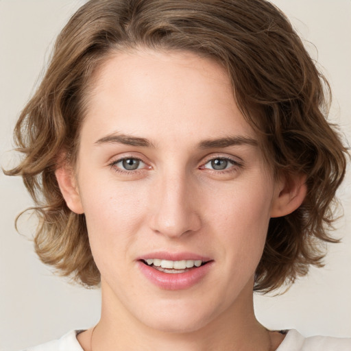 Joyful white young-adult female with medium  brown hair and green eyes