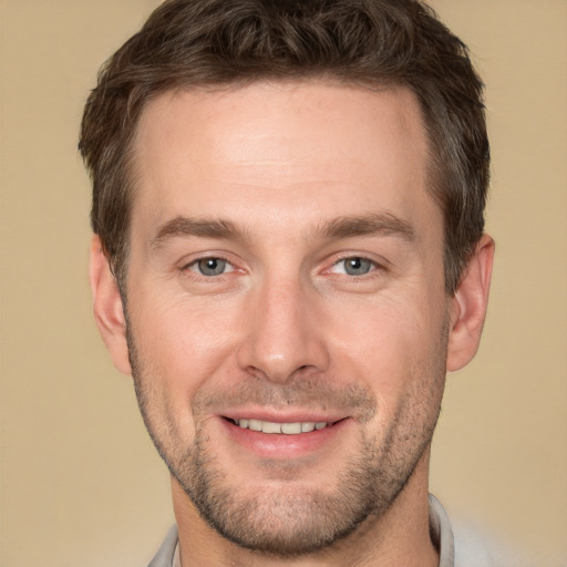 Joyful white young-adult male with short  brown hair and brown eyes