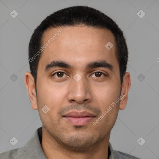 Joyful latino young-adult male with short  black hair and brown eyes