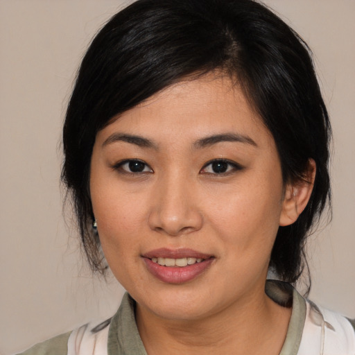 Joyful asian young-adult female with medium  black hair and brown eyes