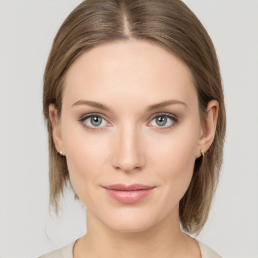 Joyful white young-adult female with medium  brown hair and green eyes