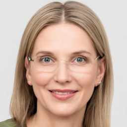 Joyful white adult female with long  brown hair and grey eyes