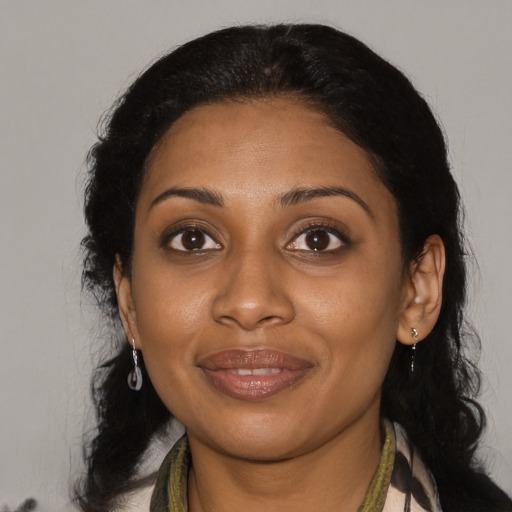 Joyful black young-adult female with medium  black hair and brown eyes