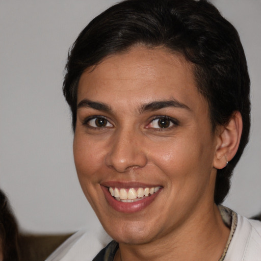 Joyful white young-adult female with short  brown hair and brown eyes