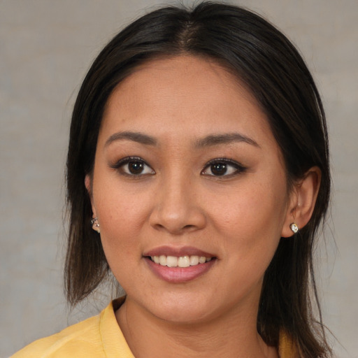 Joyful asian young-adult female with medium  brown hair and brown eyes