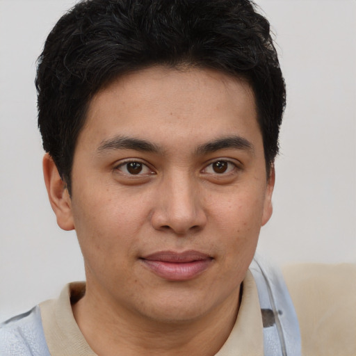 Joyful latino young-adult male with short  brown hair and brown eyes