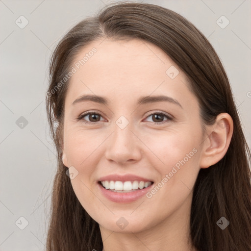 Joyful white young-adult female with long  brown hair and grey eyes