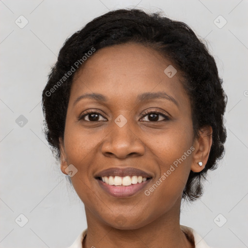 Joyful black adult female with long  brown hair and brown eyes