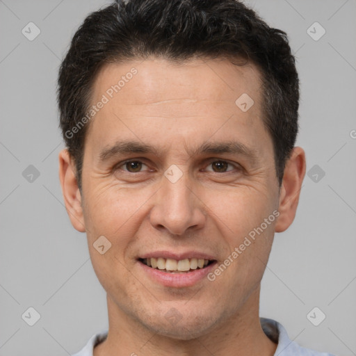 Joyful white adult male with short  brown hair and brown eyes