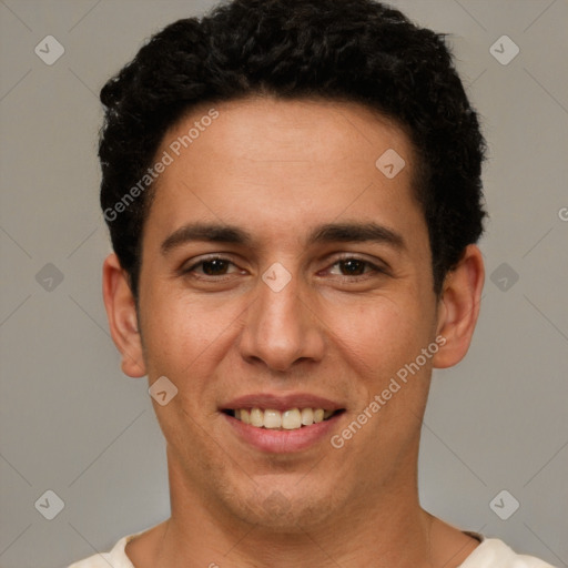 Joyful white young-adult male with short  black hair and brown eyes