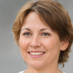 Joyful white adult female with medium  brown hair and brown eyes