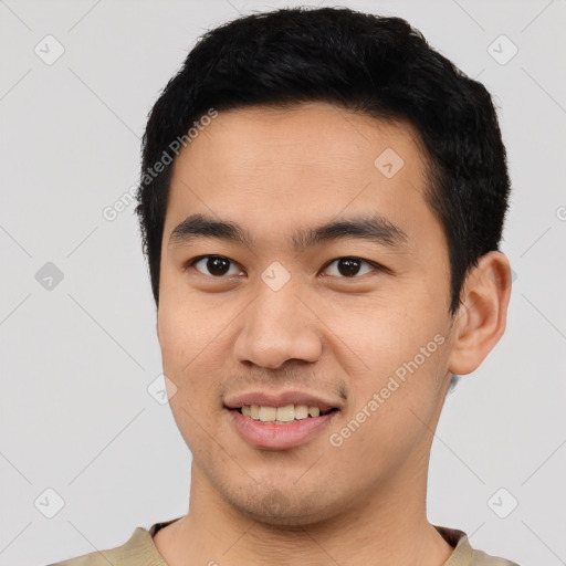 Joyful asian young-adult male with short  black hair and brown eyes