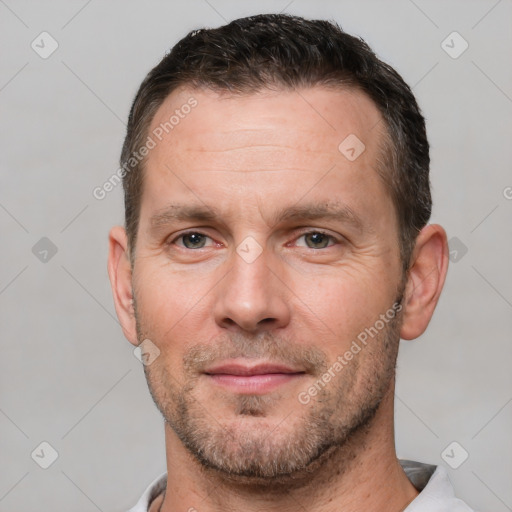 Joyful white adult male with short  brown hair and brown eyes