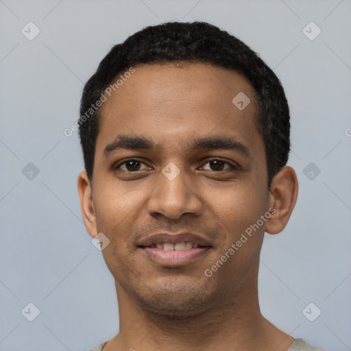 Joyful black young-adult male with short  black hair and brown eyes