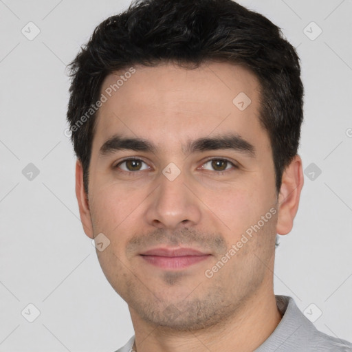 Joyful white young-adult male with short  black hair and brown eyes