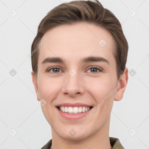 Joyful white young-adult male with short  brown hair and grey eyes