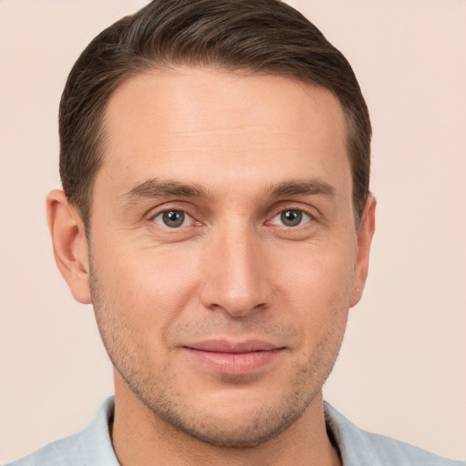 Joyful white young-adult male with short  brown hair and brown eyes