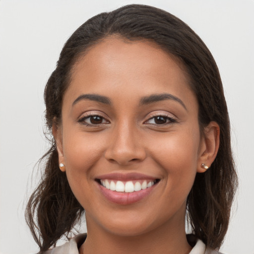 Joyful white young-adult female with long  brown hair and brown eyes