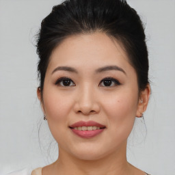 Joyful asian young-adult female with medium  brown hair and brown eyes