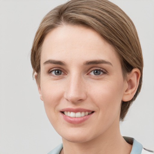 Joyful white young-adult female with medium  brown hair and grey eyes