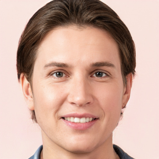 Joyful white young-adult male with medium  brown hair and grey eyes