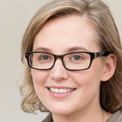 Joyful white young-adult female with medium  brown hair and blue eyes