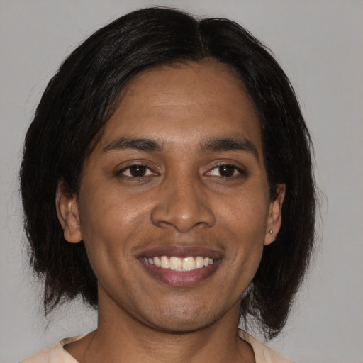 Joyful black young-adult male with medium  brown hair and brown eyes