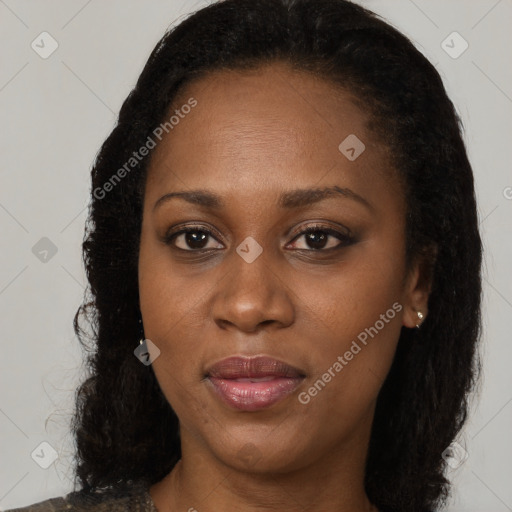 Joyful black young-adult female with long  brown hair and brown eyes