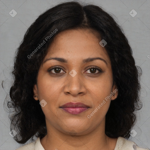 Joyful black young-adult female with long  brown hair and brown eyes