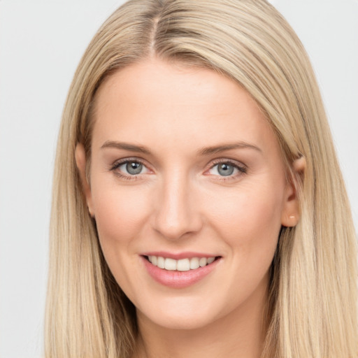 Joyful white young-adult female with long  brown hair and blue eyes