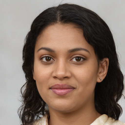 Joyful black young-adult female with medium  brown hair and brown eyes