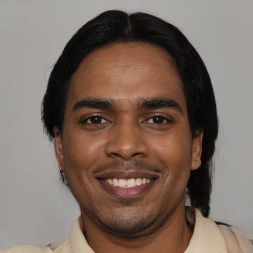 Joyful black young-adult male with short  black hair and brown eyes
