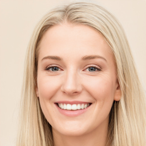 Joyful white young-adult female with long  brown hair and blue eyes