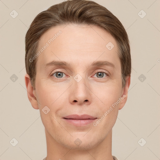 Joyful white young-adult male with short  brown hair and grey eyes