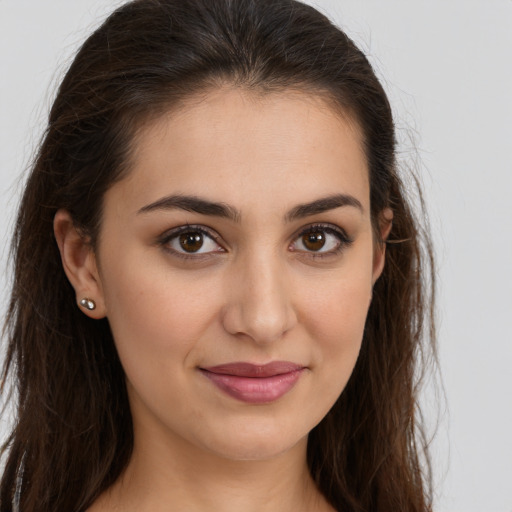 Joyful white young-adult female with long  brown hair and brown eyes