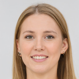 Joyful white young-adult female with long  brown hair and green eyes