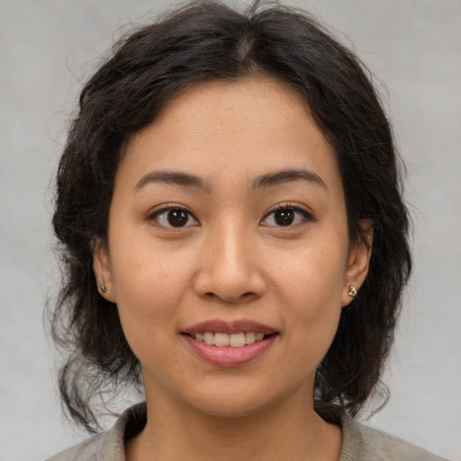 Joyful asian young-adult female with medium  brown hair and brown eyes