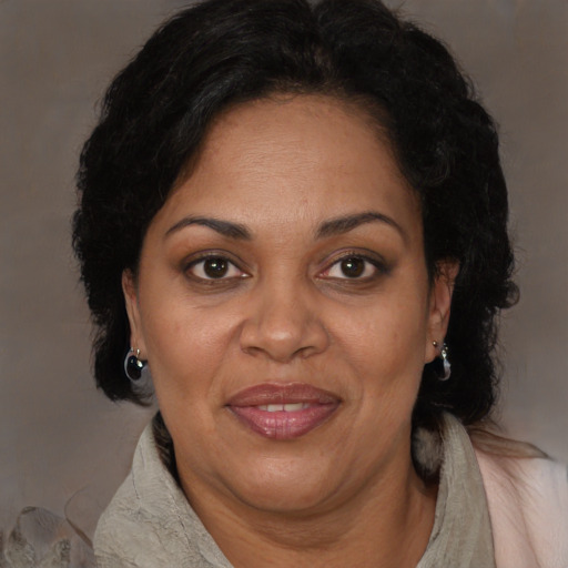 Joyful black adult female with long  brown hair and brown eyes