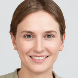 Joyful white young-adult female with short  brown hair and grey eyes