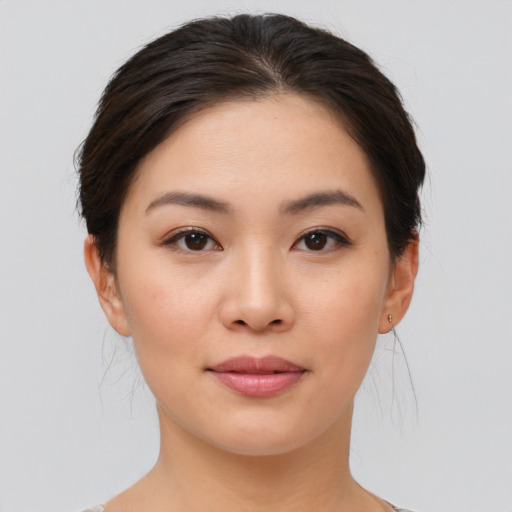 Joyful asian young-adult female with medium  brown hair and brown eyes