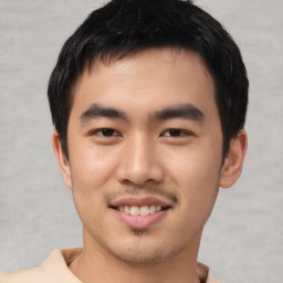 Joyful asian young-adult male with short  black hair and brown eyes