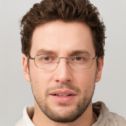 Joyful white adult male with short  brown hair and grey eyes