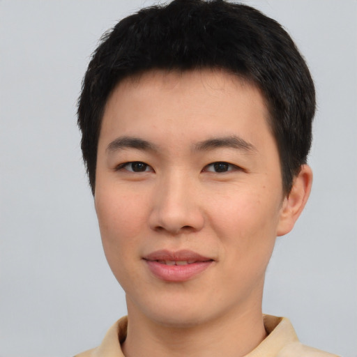 Joyful asian young-adult male with short  black hair and brown eyes