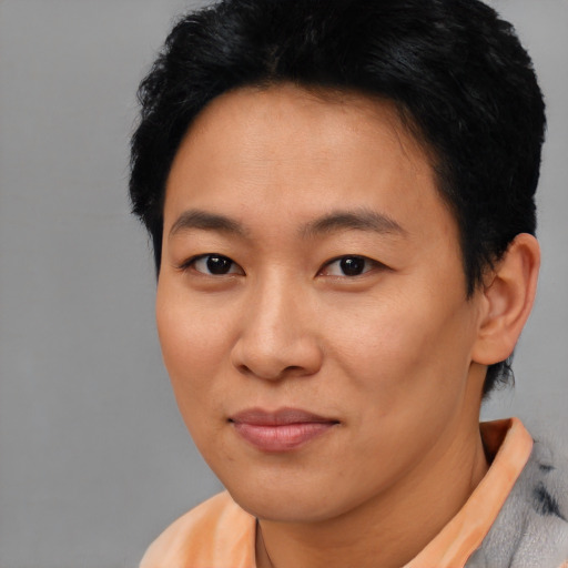 Joyful asian young-adult female with short  black hair and brown eyes