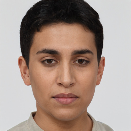 Joyful latino young-adult male with short  brown hair and brown eyes