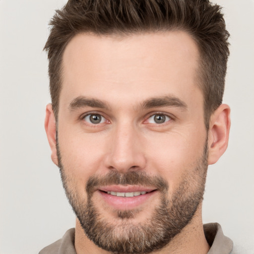 Joyful white young-adult male with short  brown hair and brown eyes