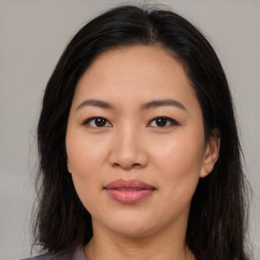 Joyful asian young-adult female with long  brown hair and brown eyes