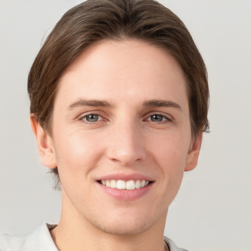 Joyful white young-adult female with short  brown hair and grey eyes