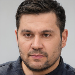 Joyful white adult male with short  brown hair and brown eyes